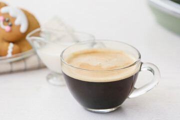 Cup of hot espresso on table in kitchen