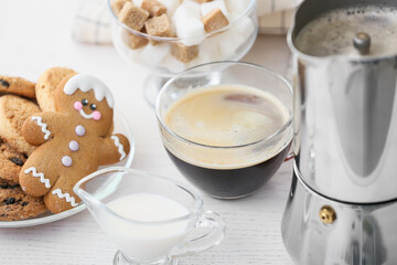 Coffee maker, cookies and cup of espresso on table in kitchen