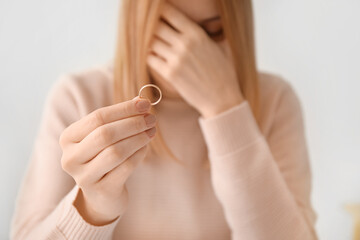 Woman with her wedding ring. Concept of divorce