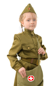 A little girl with blue eyes in a Soviet military nurse's uniform. Concept for the Victory Day in World War II on May 9