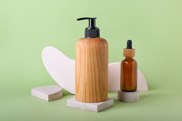 Bottles of cosmetics for hair on color background