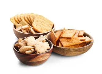 Bowls with tasty different crackers on white background