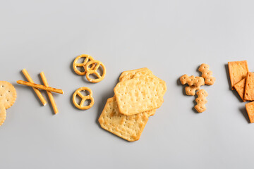 Tasty different crackers on light background