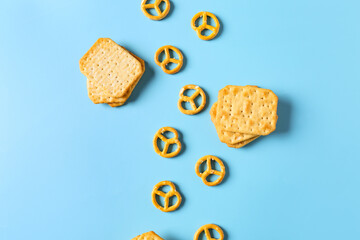 Tasty different crackers on color background