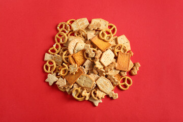 Tasty different crackers on color background