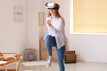 Young woman with virtual reality glasses at home