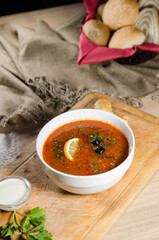 soup with meat and vegetables in white plate. solyanka. russian soup.