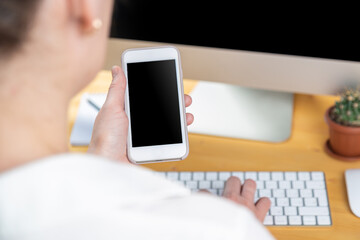 hands of women who use laptop keyboard and mobile phone. concept of email delivery and use of online technology