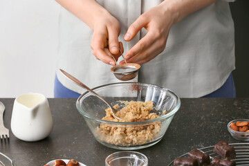 Woman preparing tasty chocolate candies in kitchen, closeup