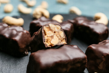 Tasty chocolate candies with nuts on table, closeup