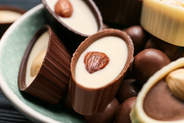Bowl with tasty chocolate candies, closeup
