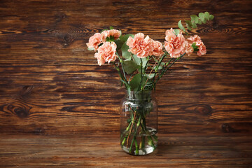 Bouquet of beautiful carnation flowers on wooden background