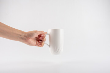hand and white cup isolated on white background