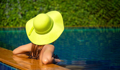 Fototapeta na wymiar Women relaxing near luxury swimming pool