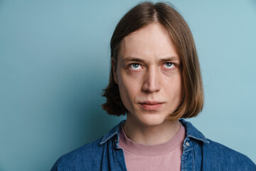 Fototapeta premium Young european man frowning and looking upward