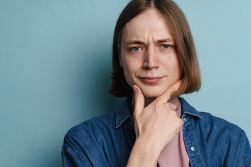 Young european man frowning and looking at camera