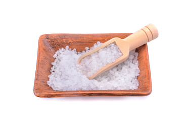 Sea salt in a salt shaker with a wooden ladle isolated on a white background.