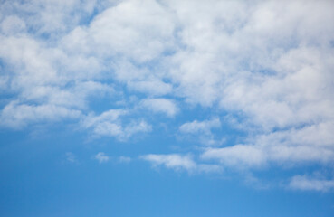 Naklejka na ściany i meble Blue sky with clouds. Background with copy space. Calm image.