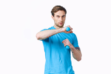 sports man with dumbbells in hands workout fitness light background