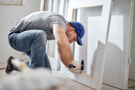 Young adult man working on a DIY budget renovation of his new home apartment.