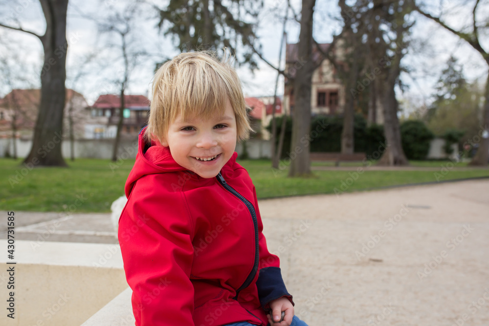 Canvas Prints Cute child, toddler boy, playing hopscotch, running and riding bike in the park