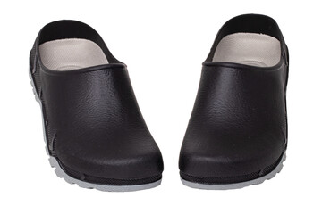 Closeup of a comfortable pair of black garden or work clogs isolated on a white background. The shoes are waterproof, easy-care and dirt-repellent and ideal for gardening. Macro.