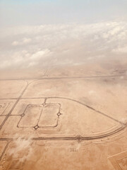 Airplane passenger window view to a suburbs of Doha, Qatar.