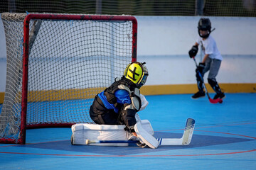 Children playing hockeyball on playground