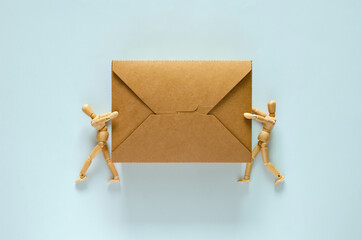 Fototapeta premium Two wooden models holding disposable, compostable paper food box for world environment day concept.