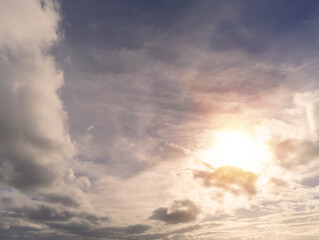 The sun in a cloudy sky. Natural background with place for text. Beautiful cloudscape. Clouds make u shape