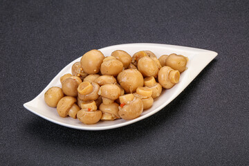 Pickled champignons in the bowl