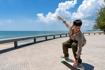 Young asian man riding surfskate board. Trendy outdoor sport in Thailand, Asia. - 430734956