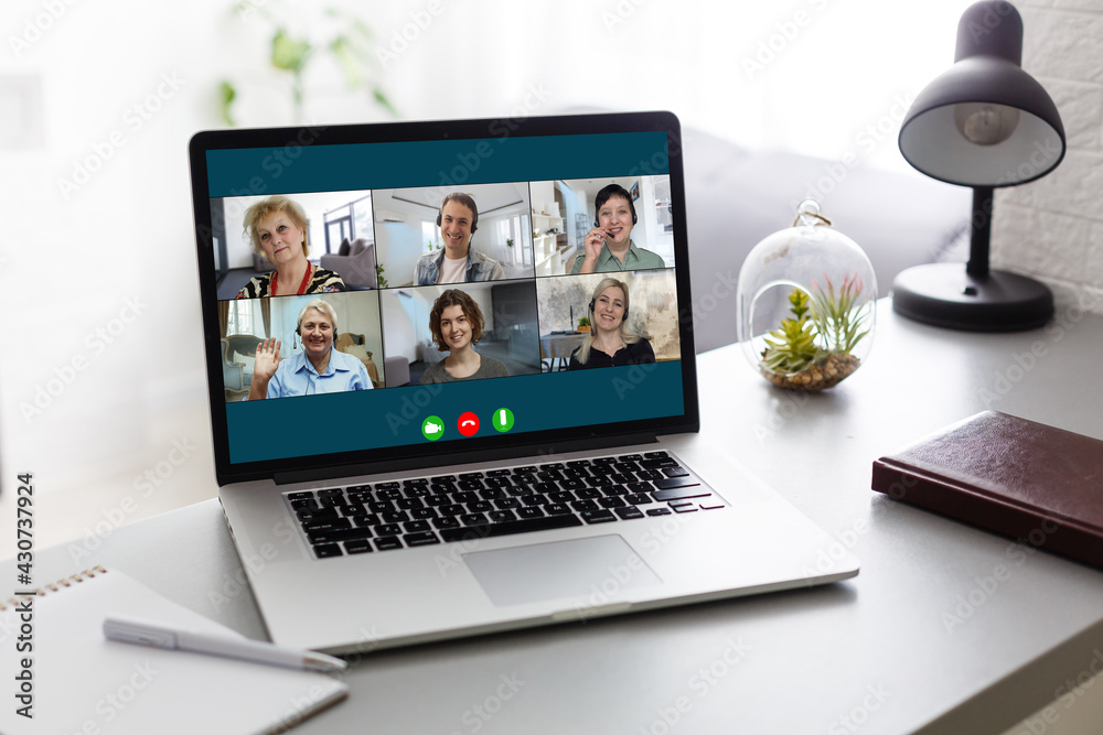 Wall mural Virtual meeting online. Video conference by laptop. Online business meeting. On the laptop screen, people who gathered in a video conference to work on-line