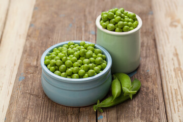 Green peas on wooden board