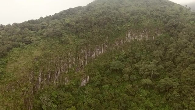 Aerial footage landscape view of green rain forest and rock cliff in Bandungan national park, Central Java, Indonesia