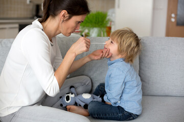 Mother, testing her child for covid at home, making home allowed swab tests