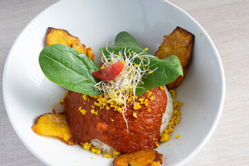Isolated bowl of Cuban rice with fried plantain.
