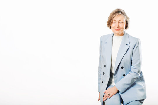 Studio Portrait Of Middle Age Woman Posing On White Background