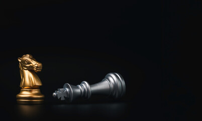 Golden knight horse standing and silver king chess falling , Winner of business competition and marketing strategy planing concept.