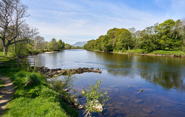 Views from the riverbank of the River Tay by the village of Aberfeldy in Perthshire in the Scottish Highlands on a sunny spring day.