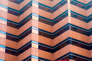 Glass windows of modern orange skyscraper