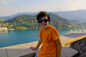 Portrait of happy boy is smiling at camera in Lake Bled,Slovenia	