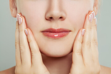 Manicure. Woman touching her face her hand with manicured nails
