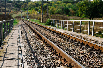 Obraz premium Ukrainian railway parallel metal old truck for trains with stones at nature background