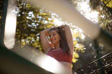 Pregnant woman working exercise outside. Focus is on woman.