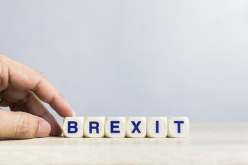 A word "Brexit" on a wooden table over the light background. 