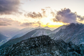 sunset over st. Anton in Tirol with a view of the summit cross in the background with a panoramic view.