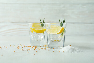 Shots of tequila on white textured table