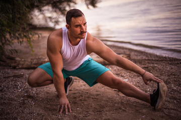 Fototapeta premium Young sports man working exercise on the beach.