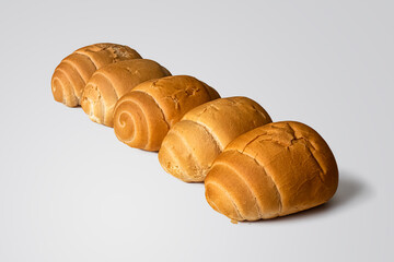 Row of several golden-crusted buns